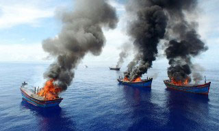 Arial view of Palau burning illegal Vietnamese fishing boats