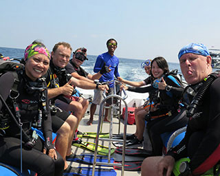 Happy divers, including Jim diving from White Manta's tender
