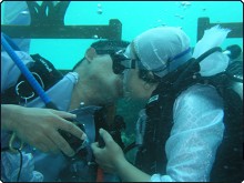 Couple seals their wedding with a kiss under the sea at Mataking Reef Dive Resort, Malaysia