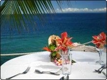 The Fijian surrounds of the outdoor dining setting at Paradise Taveuni Resort is irresistible